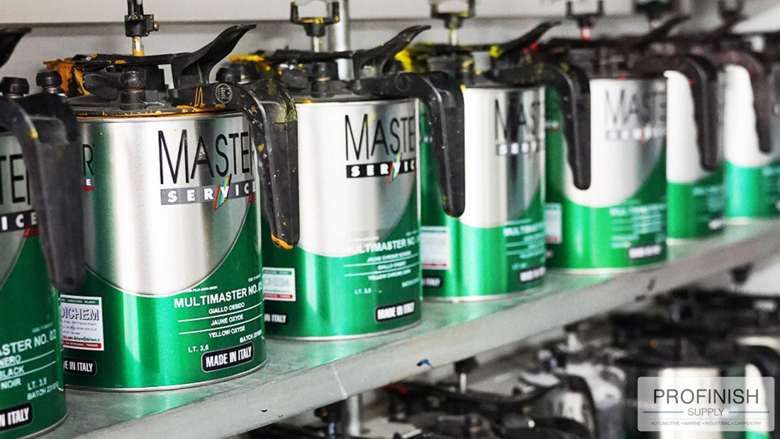 Cans of Master Service automotive refinish paint system by Dichem Italy arranged in a professional mixing station, made in Italy.